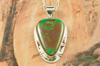 Genuine Manassa Turquoise set in Sterling Silver Pendant. This Turquoise is also referred to as King�s Manassa Turquoise. The Manassa Turquoise mine is located in Manassa, Conejos County, Colorado. Created by Navajo Artist Phillip Sanchez. Signed by the artist. Free 18